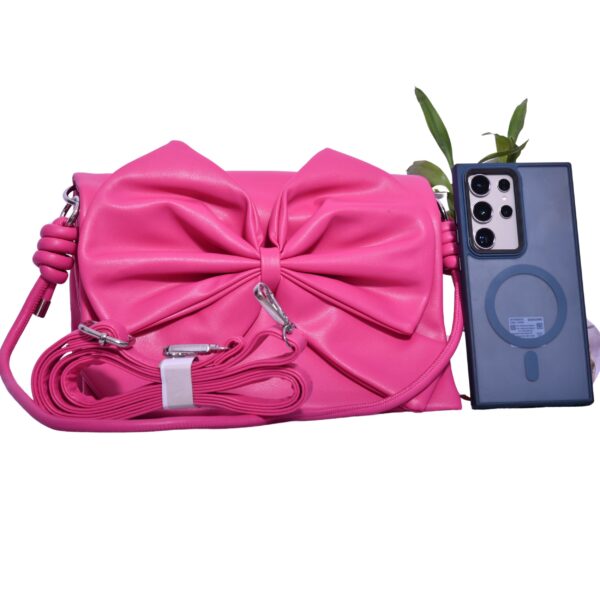 pink bow sling bag with chain and leather straps